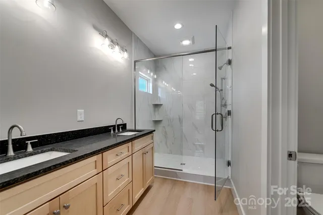 a spacious bathroom with a shower sink and mirror