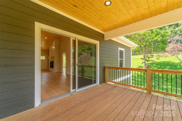 a view of hallway with wooden floor