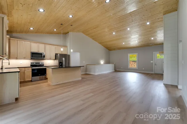 a view of kitchen with cabinets and wooden floor