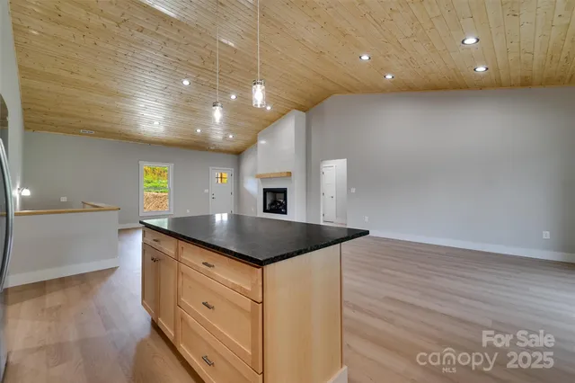 a kitchen with granite countertop a sink and cabinets