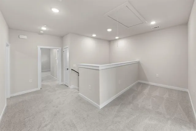 an empty room with white walls and entryway