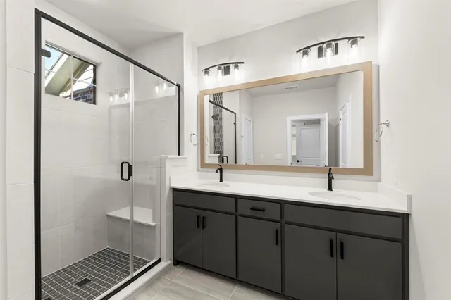 a bathroom with a double vanity sink and mirror