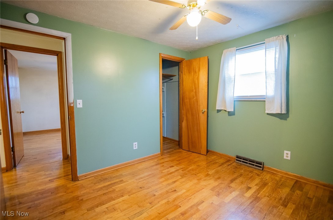 91 Mike Street Washington, WV 26181 - Photo 20 of 42 Unfurnished bedroom with wood finished floors, ceiling fan, and a textured ceiling