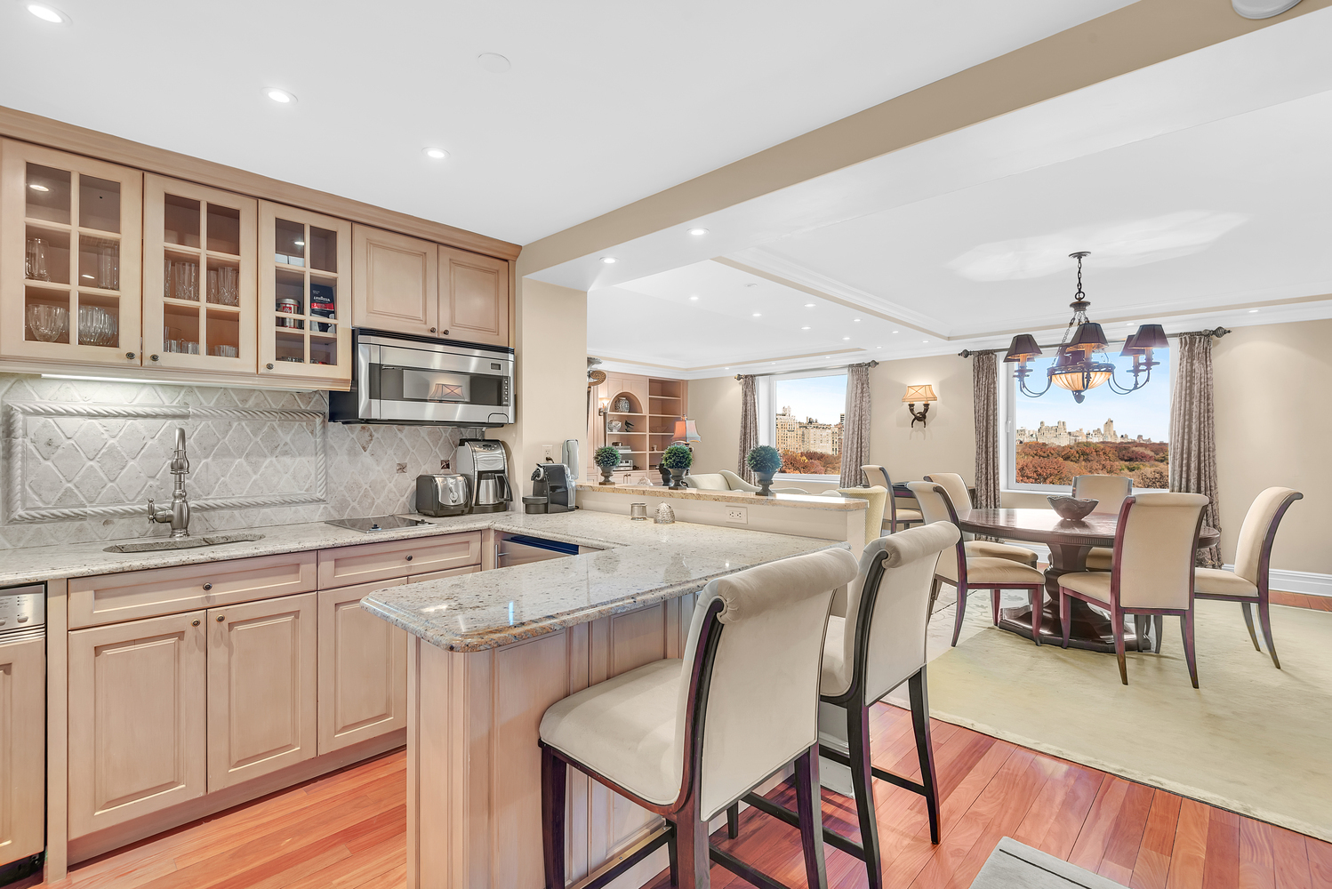 160 Central Park South, Unit 1015/1018 Manhattan, NY 10019 - Photo 6 of 15 a kitchen with sink a center island and cabinets