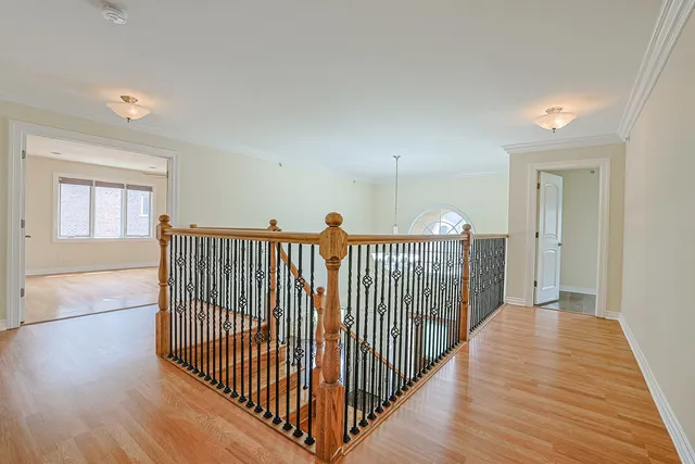 a view of a hallway view with wooden floor and staircase