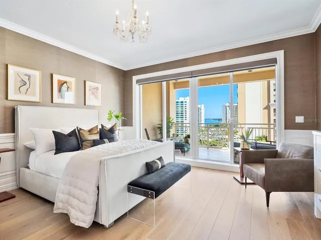 a dining room with furniture a chandelier and window