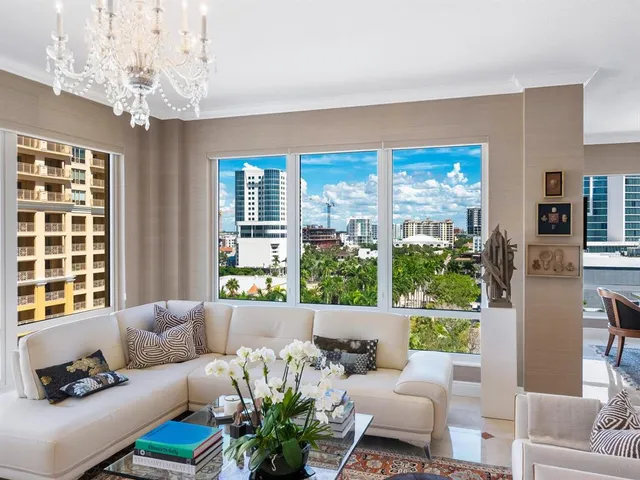 a living room with furniture and a dining table with kitchen view