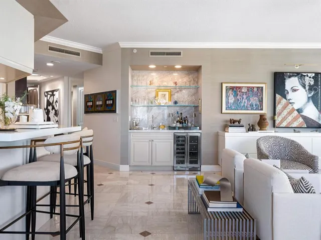 a kitchen with white cabinets and sink