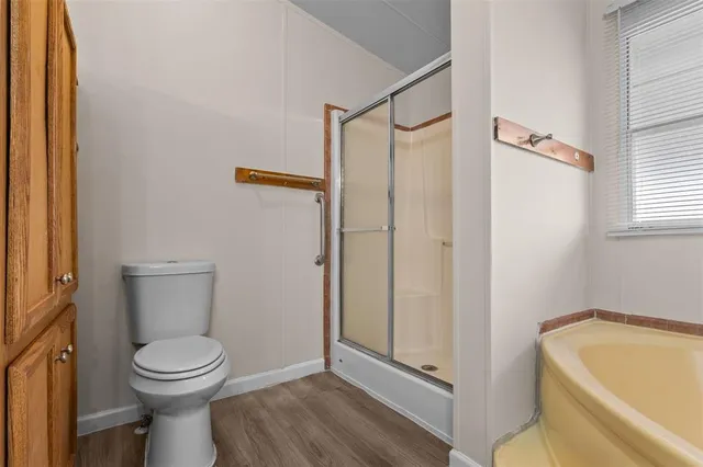a bathroom with a toilet and a shower