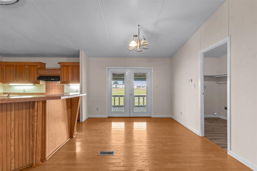 4000 Dee Drive Terrell, TX 75160 - Photo 6 of 21 wooden floor in an empty room with a window