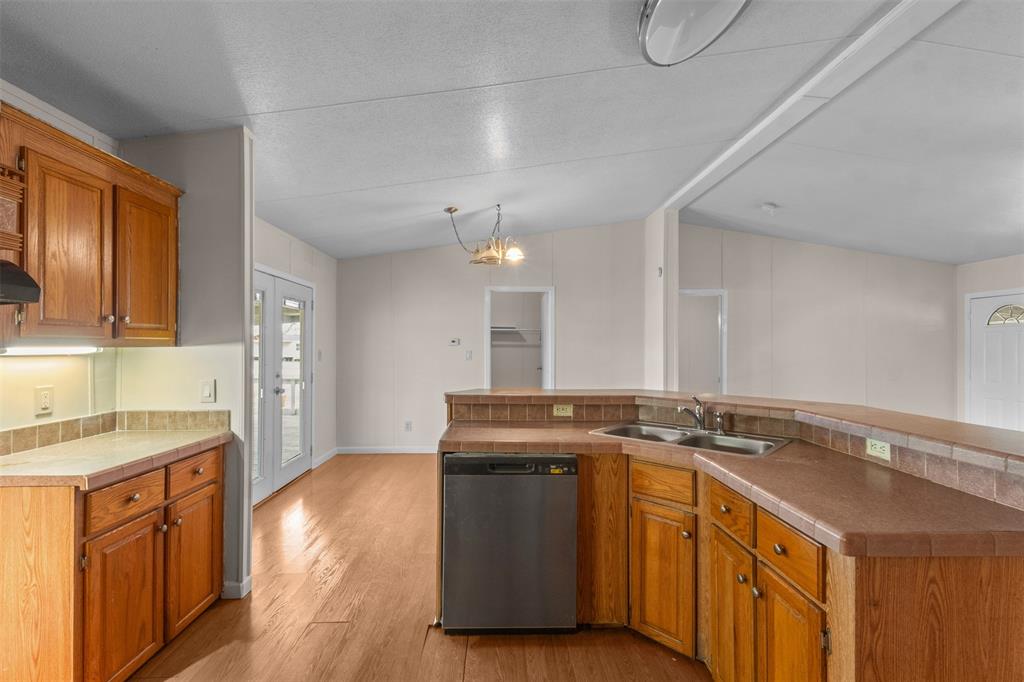 4000 Dee Drive Terrell, TX 75160 - Photo 7 of 21 a kitchen that has a sink a stove and a wooden floors