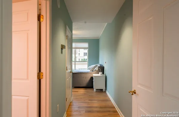 a view of a hallway and a livingroom with furniture