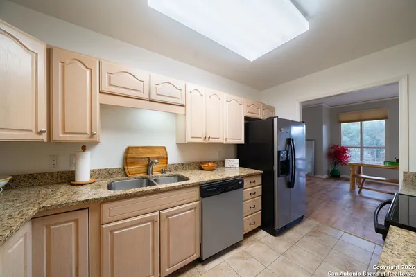 a kitchen with stainless steel appliances granite countertop a refrigerator sink and cabinets