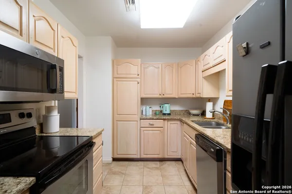 a kitchen with a sink stove and refrigerator