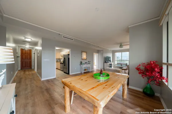 a room with painting on the wall and a dining table