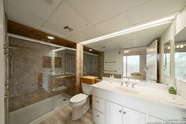 a bathroom with a sink shower and a toilet
