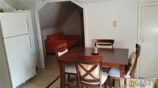 406 Fulton Street Middlesex, NJ 08846 - Photo 11 of 19 a dining room with furniture and a refrigerator
