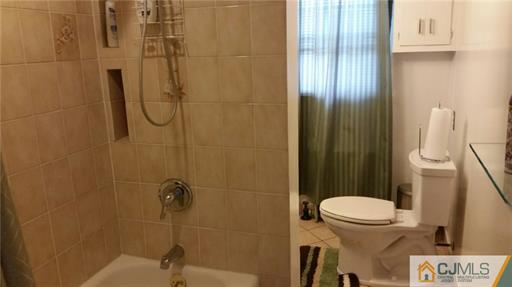 406 Fulton Street Middlesex, NJ 08846 - Photo 12 of 19 a bathroom with a sink a toilet and shower