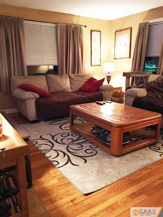406 Fulton Street Middlesex, NJ 08846 - Photo 3 of 19 a living room with furniture and a flat screen tv