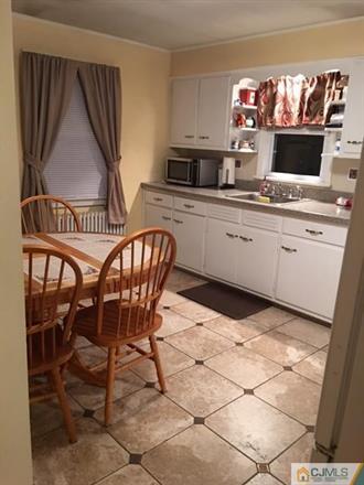 406 Fulton Street Middlesex, NJ 08846 - Photo 4 of 19 a kitchen with stainless steel appliances a stove a sink and a microwave