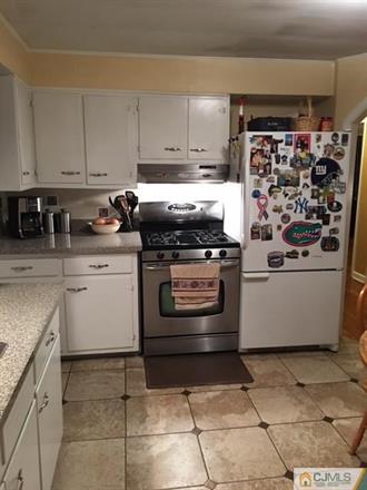 406 Fulton Street Middlesex, NJ 08846 - Photo 5 of 19 a kitchen with a stove top oven and cabinets