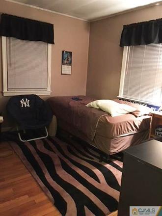 406 Fulton Street Middlesex, NJ 08846 - Photo 6 of 19 a bedroom with a bed and a window