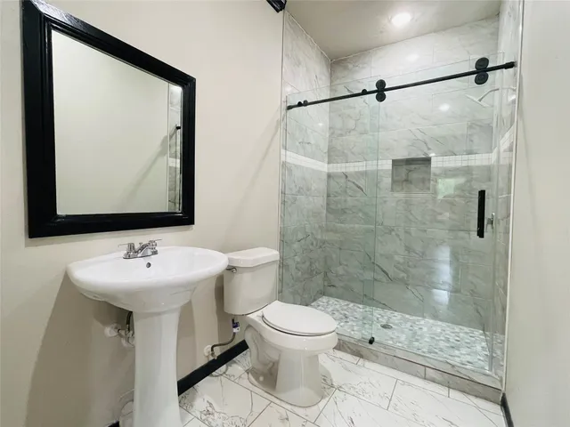 a bathroom with a sink toilet and shower