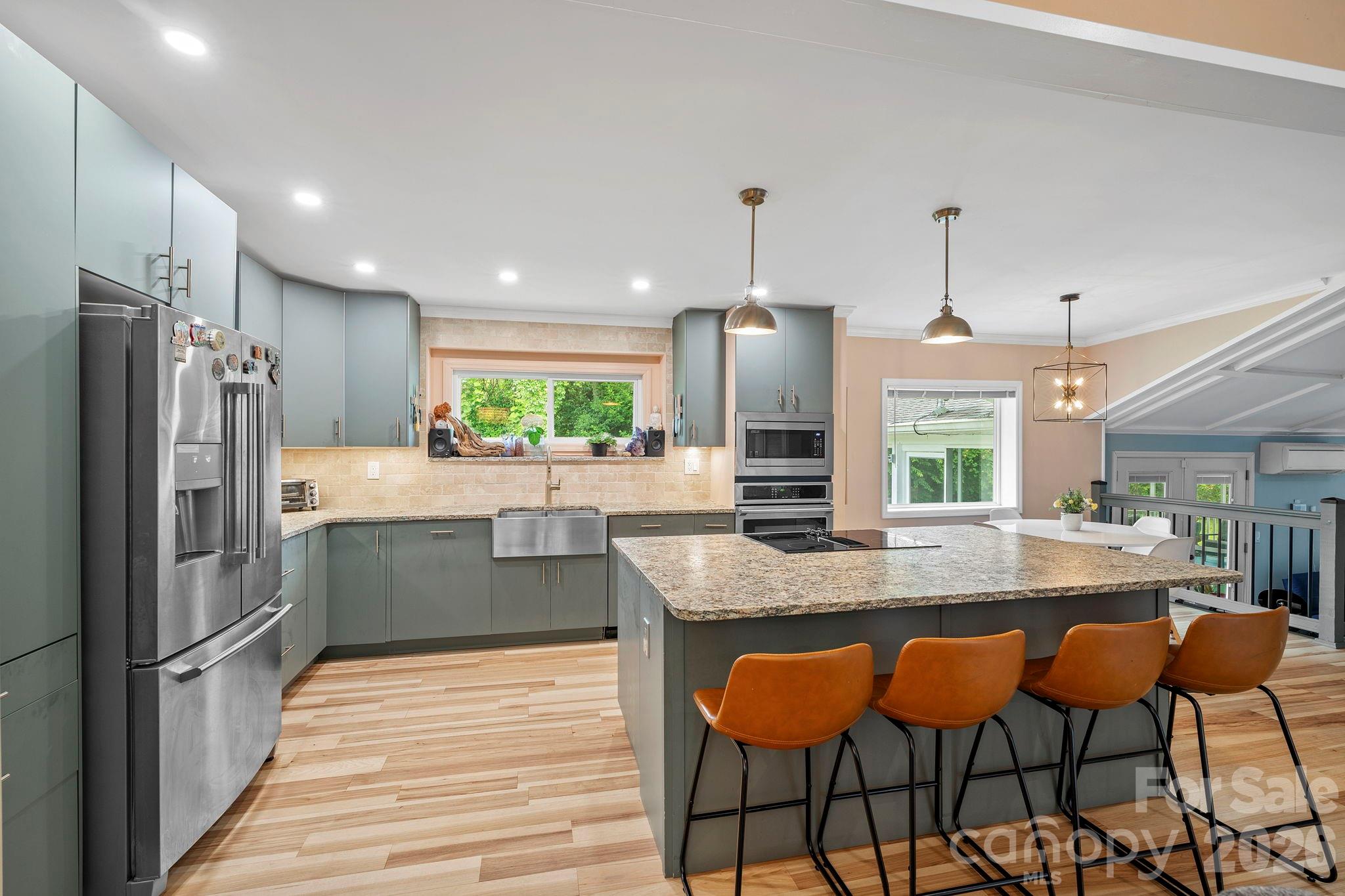 419 East Blue Ridge Road East Flat Rock, NC 28726 - Photo 11 of 44 a kitchen with stainless steel appliances granite countertop table chairs sink and cabinets