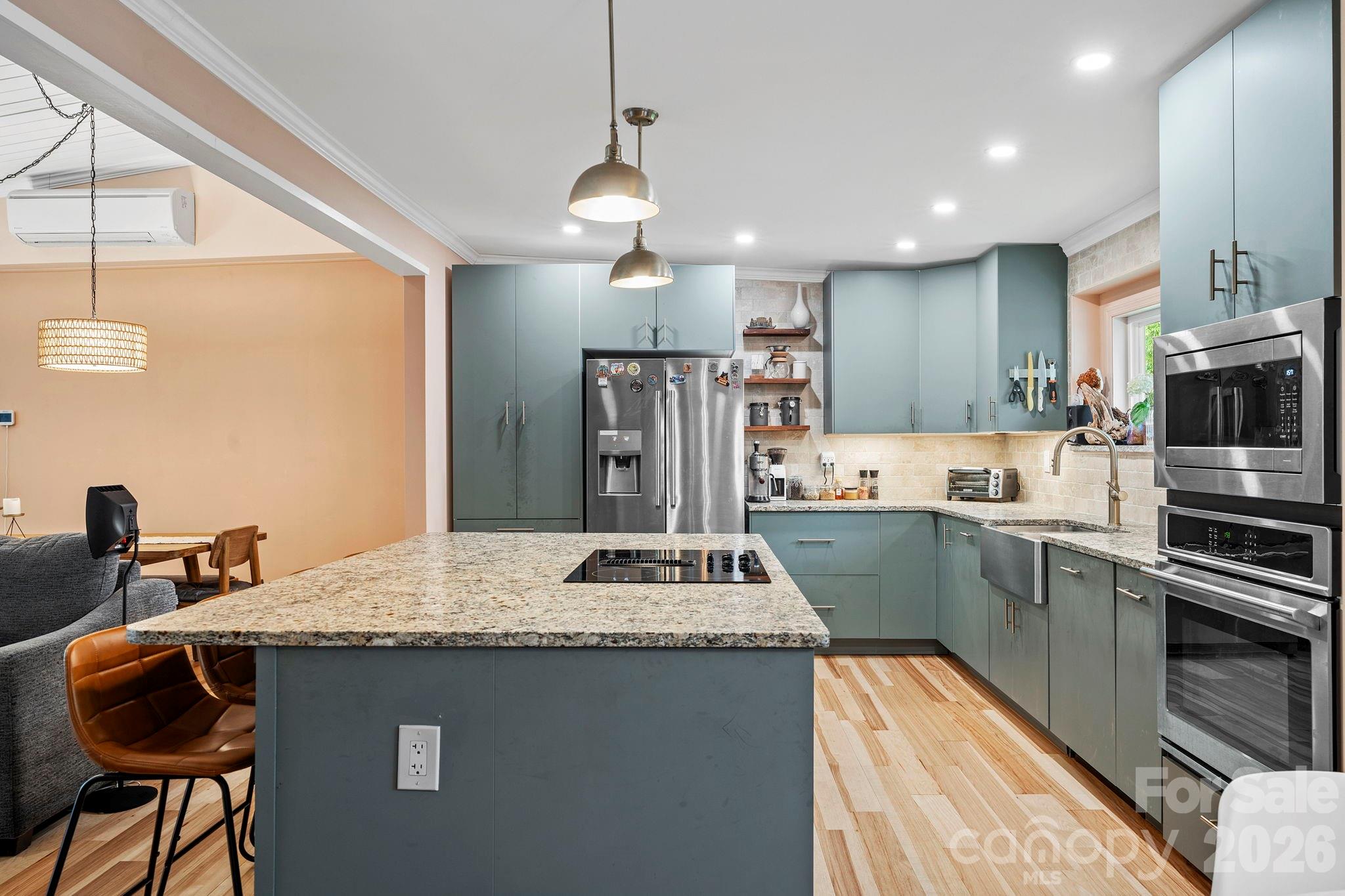419 East Blue Ridge Road East Flat Rock, NC 28726 - Photo 14 of 44 a kitchen with kitchen island a sink stove and refrigerator