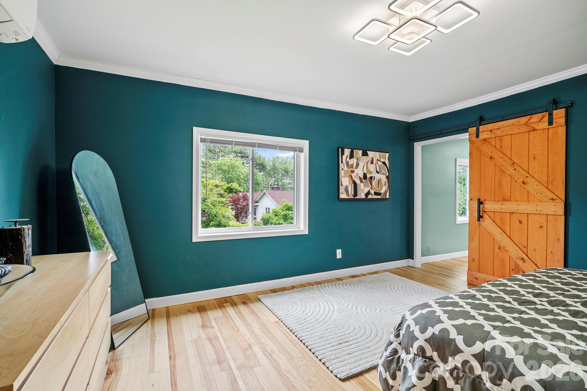 419 East Blue Ridge Road East Flat Rock, NC 28726 - Photo 18 of 44 a bedroom with a bed and a large window