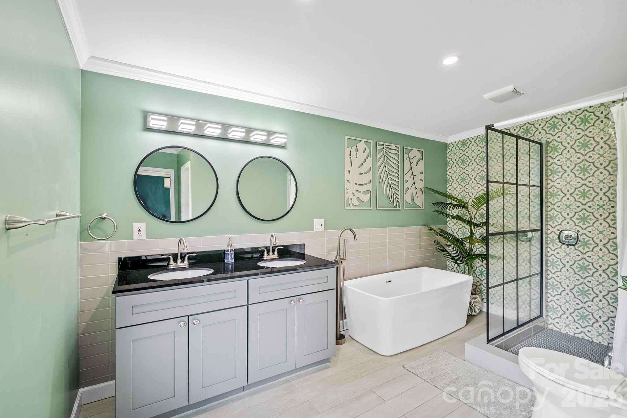 419 East Blue Ridge Road East Flat Rock, NC 28726 - Photo 19 of 44 a bathroom with a double vanity sink mirror and bathtub