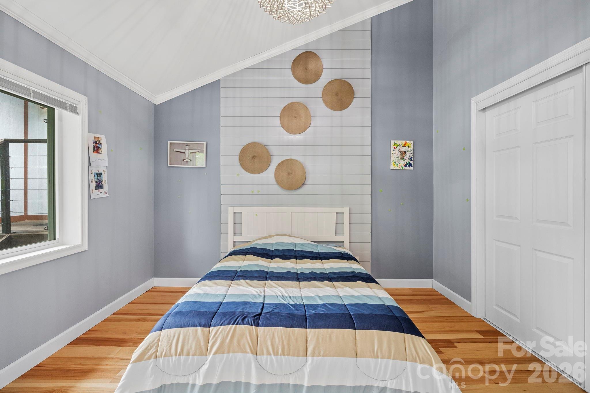 419 East Blue Ridge Road East Flat Rock, NC 28726 - Photo 24 of 44 a bedroom with a bed and a window