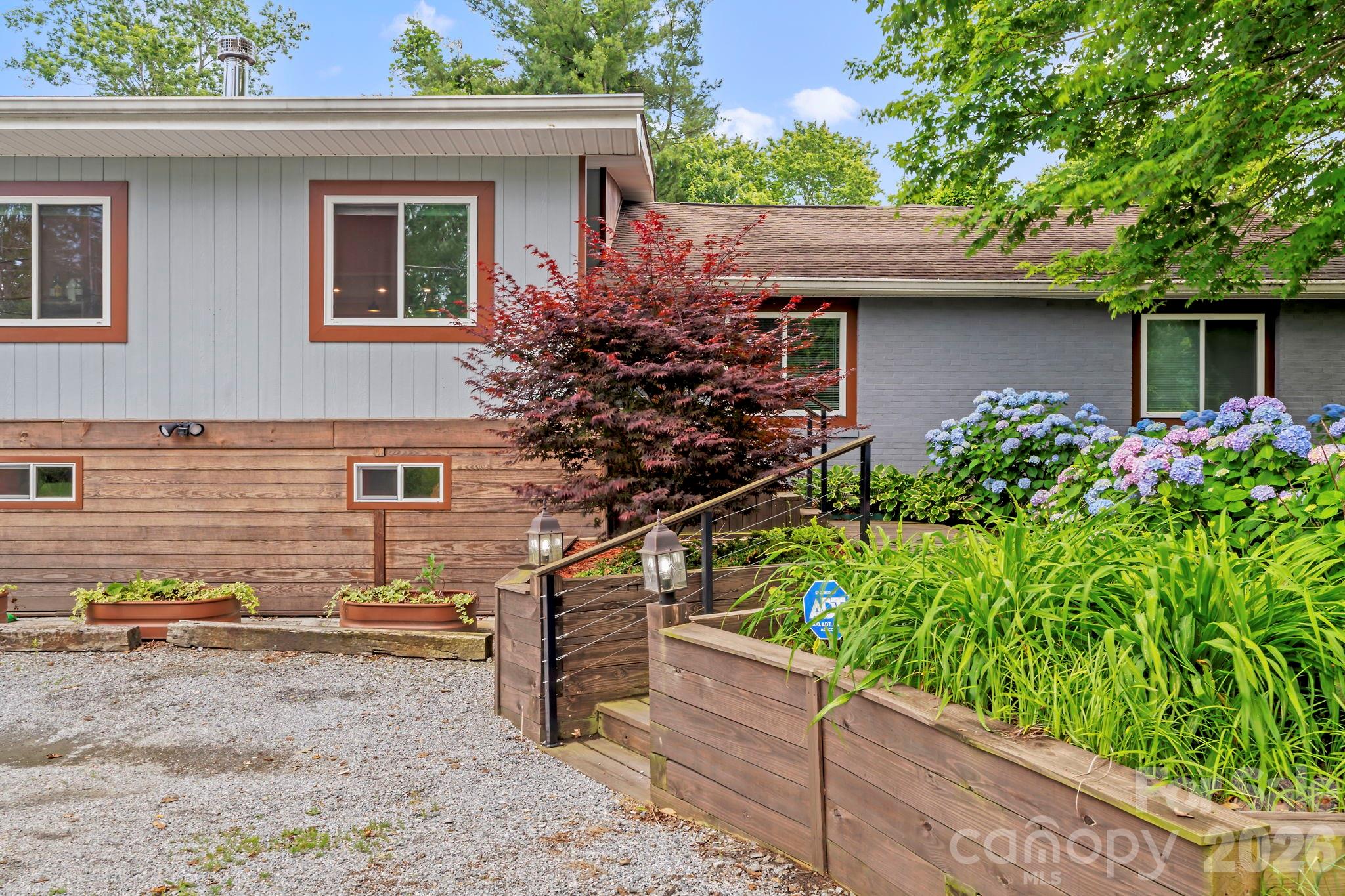 419 East Blue Ridge Road East Flat Rock, NC 28726 - Photo 3 of 44 front view of a house with a yard