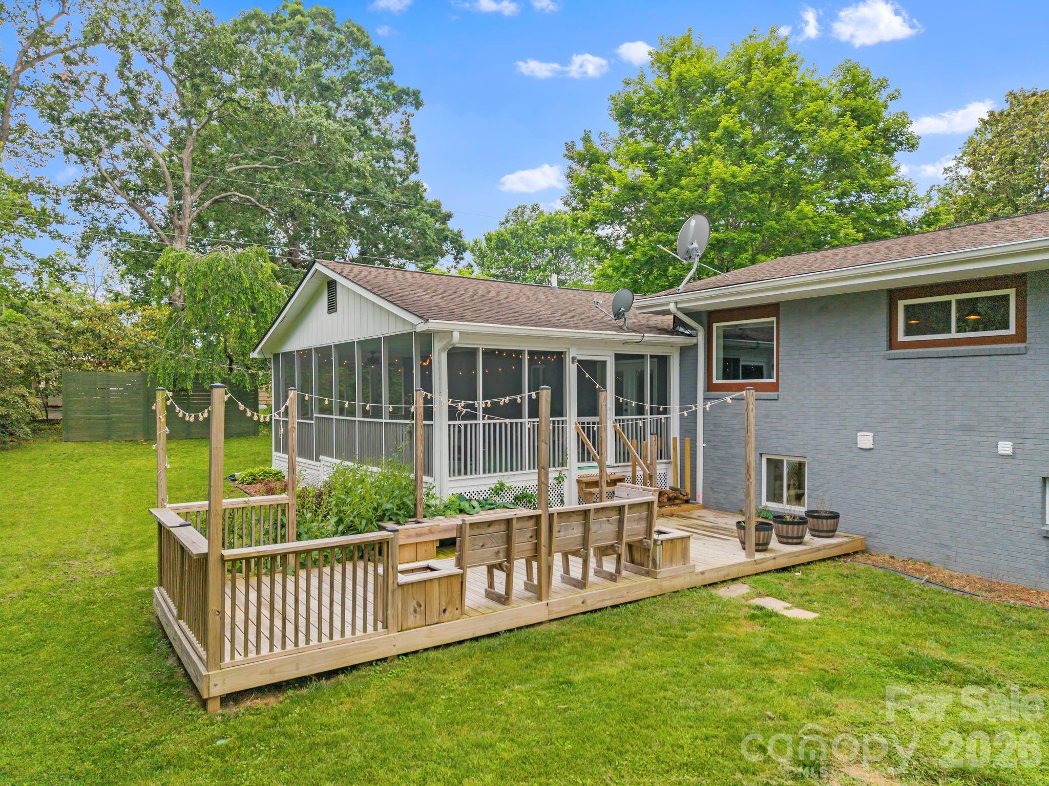 419 East Blue Ridge Road East Flat Rock, NC 28726 - Photo 37 of 44 a view of a house with a backyard and deck