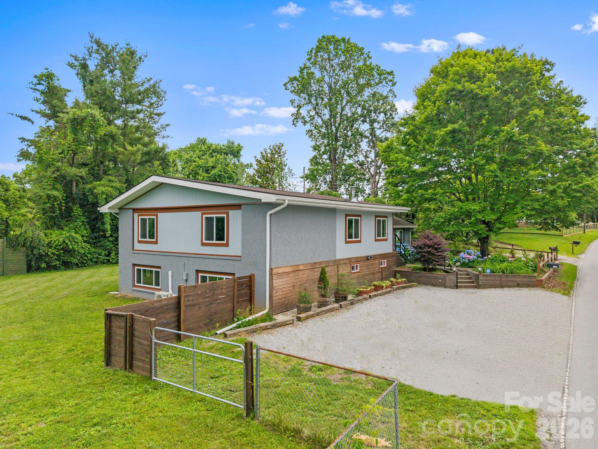 419 East Blue Ridge Road East Flat Rock, NC 28726 - Photo 42 of 44 a front view of a house with a yard