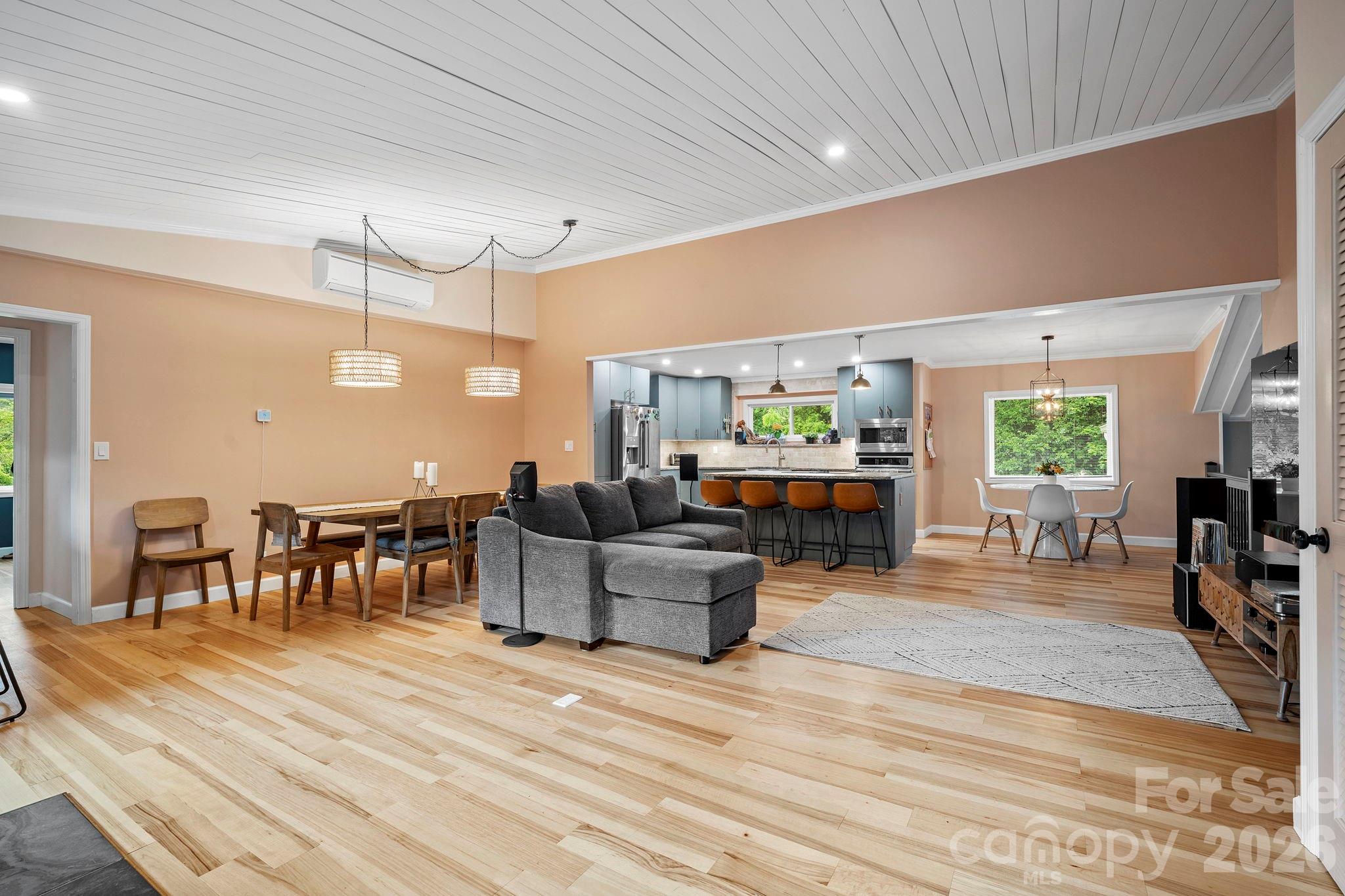 419 East Blue Ridge Road East Flat Rock, NC 28726 - Photo 7 of 44 a living room with furniture a wooden floor and dining table with wooden floor