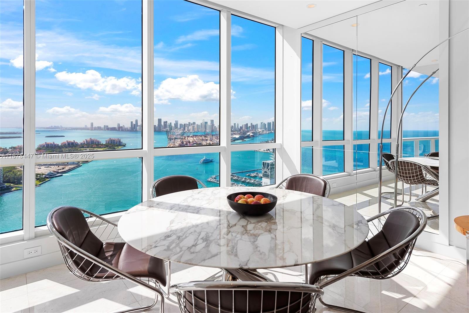 100 South Pointe Drive, Unit 3402 Miami Beach, FL 33139 - Photo 1 of 47 a view of a patio with a table chairs and a table