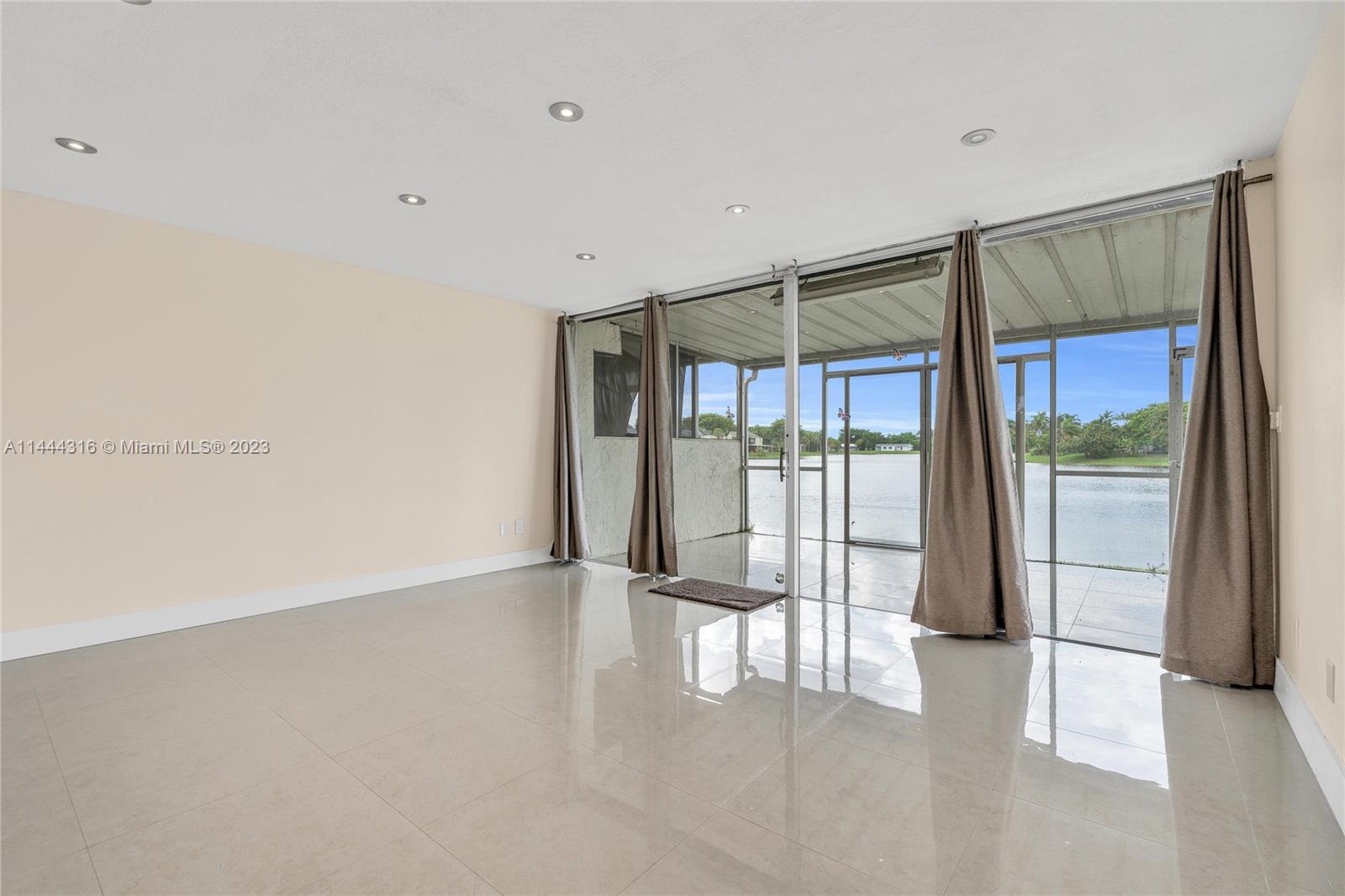14001 Southwest 84th Street, Unit 1308 Miami, FL 33183 - Photo 11 of 47 a view of an empty room with a sliding door