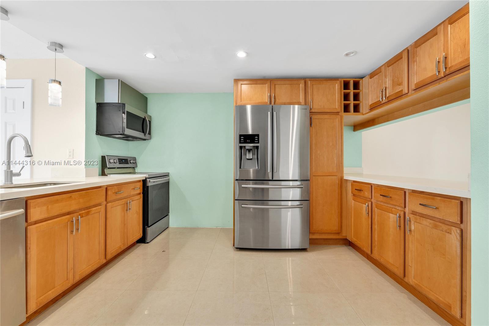 14001 Southwest 84th Street, Unit 1308 Miami, FL 33183 - Photo 13 of 47 a kitchen with stainless steel appliances granite countertop a refrigerator and a sink