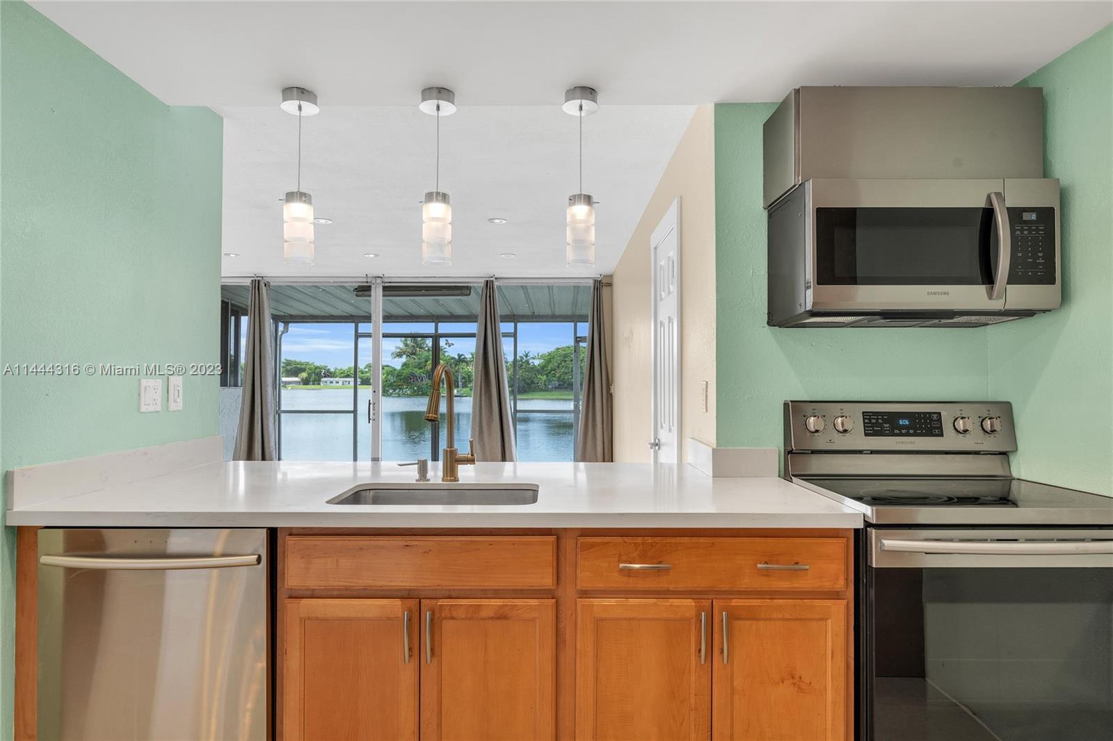 14001 Southwest 84th Street, Unit 1308 Miami, FL 33183 - Photo 14 of 47 a kitchen with a stove and a microwave