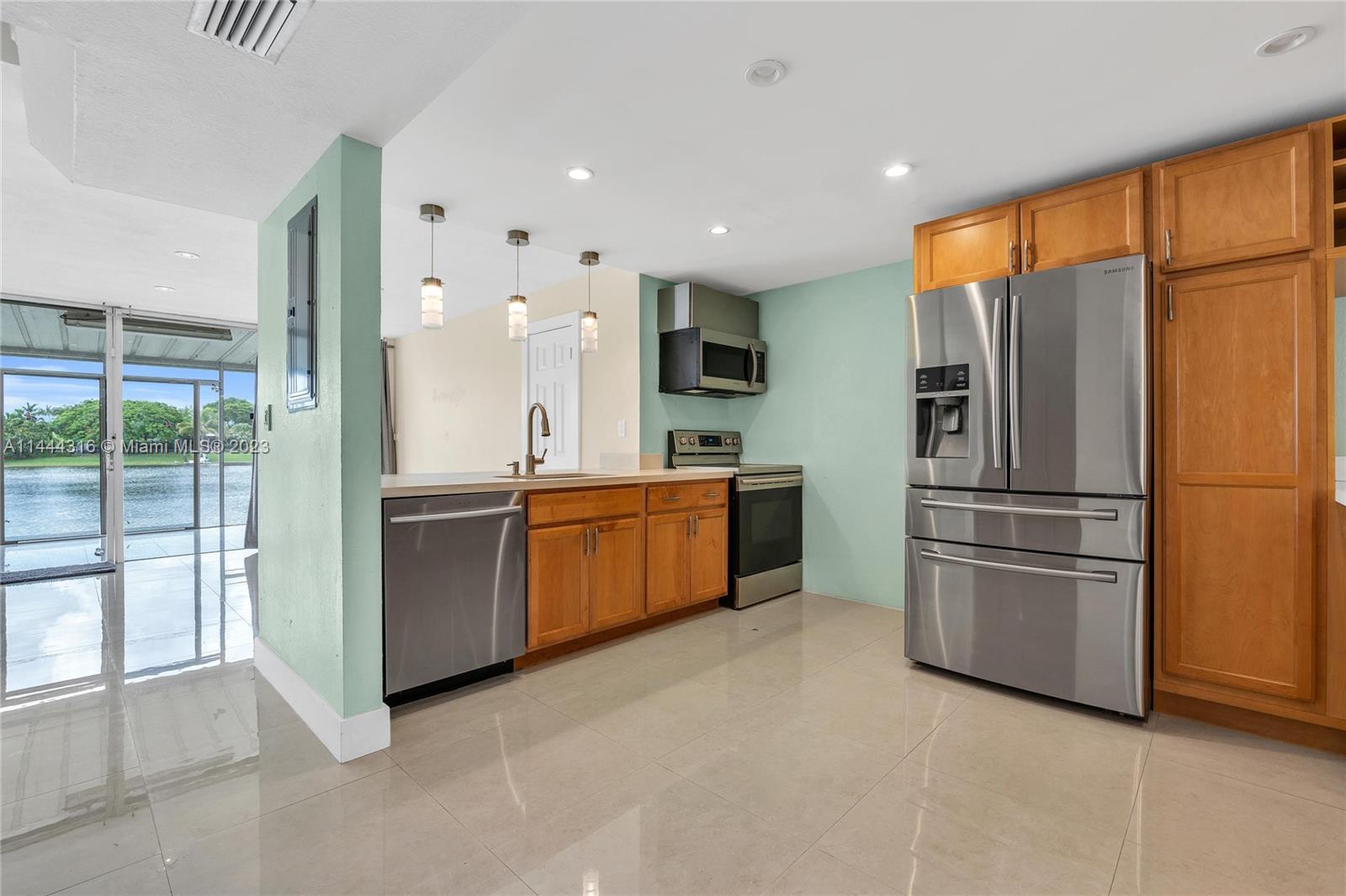 14001 Southwest 84th Street, Unit 1308 Miami, FL 33183 - Photo 16 of 47 a kitchen with stainless steel appliances a refrigerator and a sink