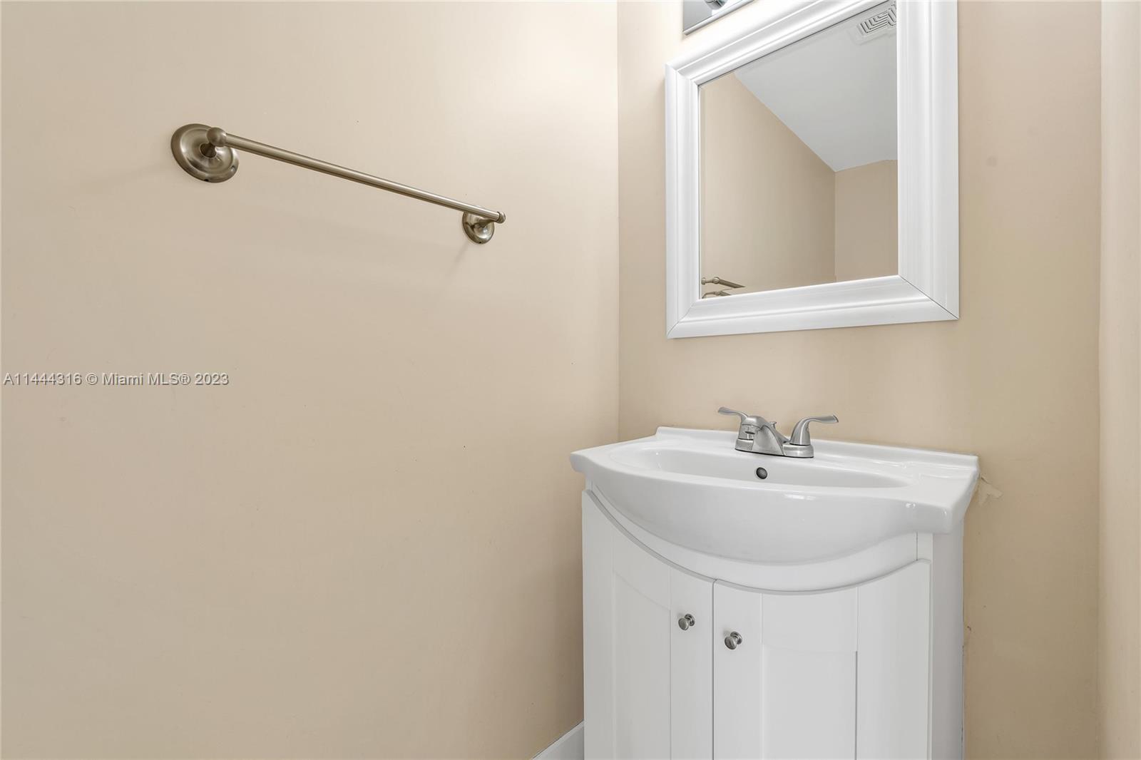 14001 Southwest 84th Street, Unit 1308 Miami, FL 33183 - Photo 20 of 47 a bathroom with a sink a mirror and a vanity