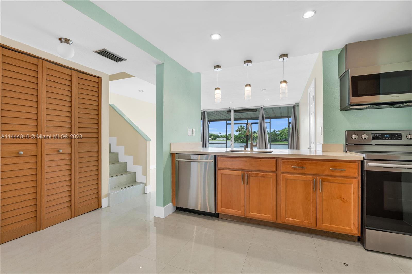14001 Southwest 84th Street, Unit 1308 Miami, FL 33183 - Photo 2 of 47 a open kitchen with granite countertop a sink and a stove top oven