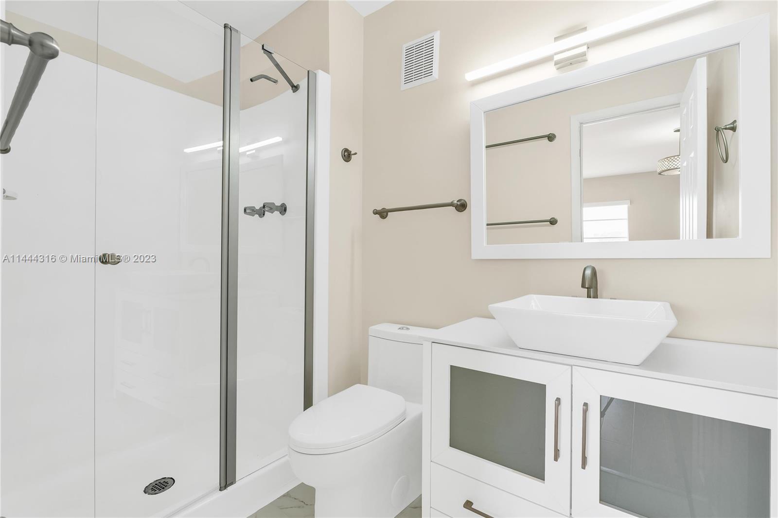 14001 Southwest 84th Street, Unit 1308 Miami, FL 33183 - Photo 21 of 47 a bathroom with a sink toilet vanity and shower