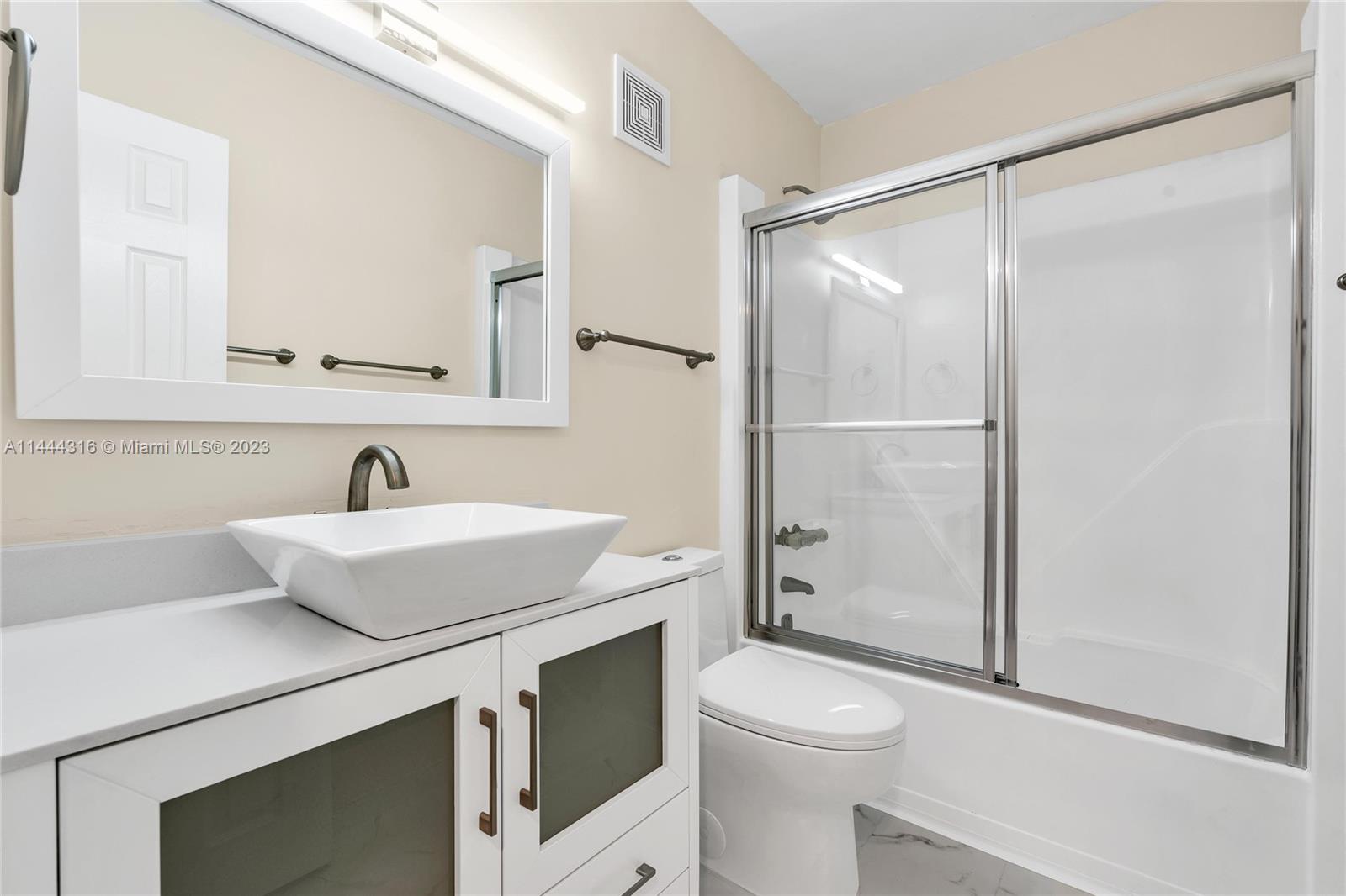 14001 Southwest 84th Street, Unit 1308 Miami, FL 33183 - Photo 25 of 47 a bathroom with a sink toilet vanity and shower