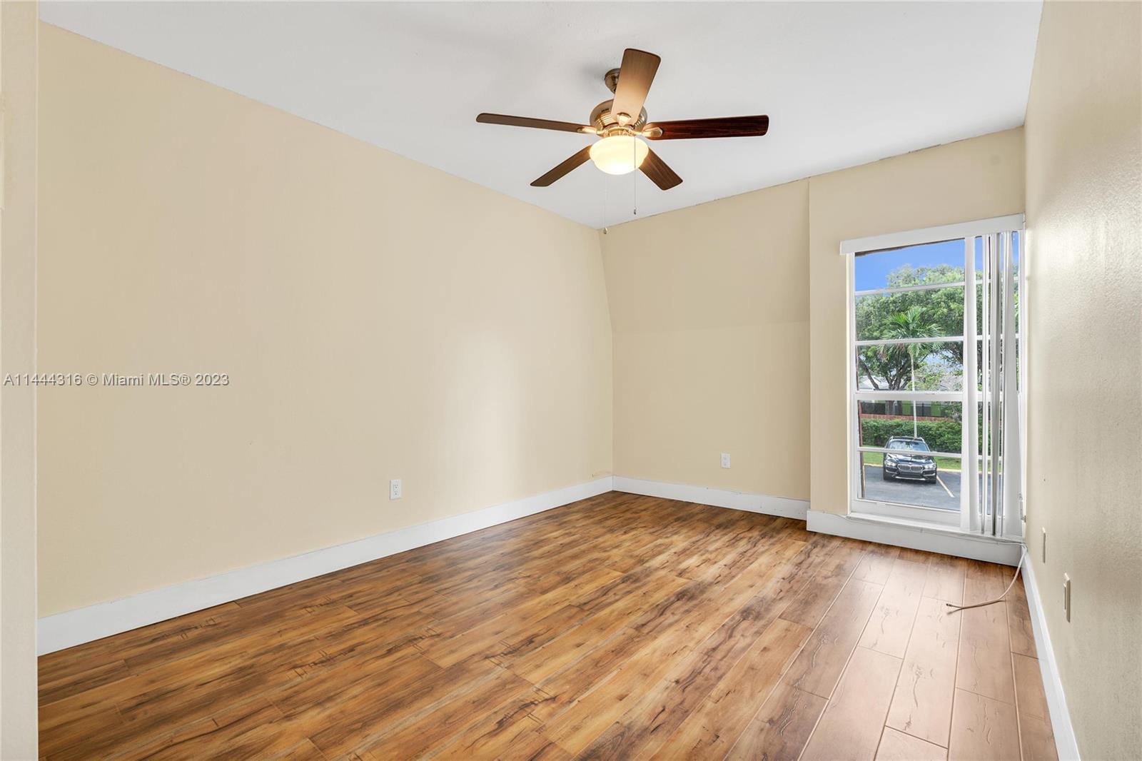14001 Southwest 84th Street, Unit 1308 Miami, FL 33183 - Photo 29 of 47 a view of empty room with wooden floor and fan