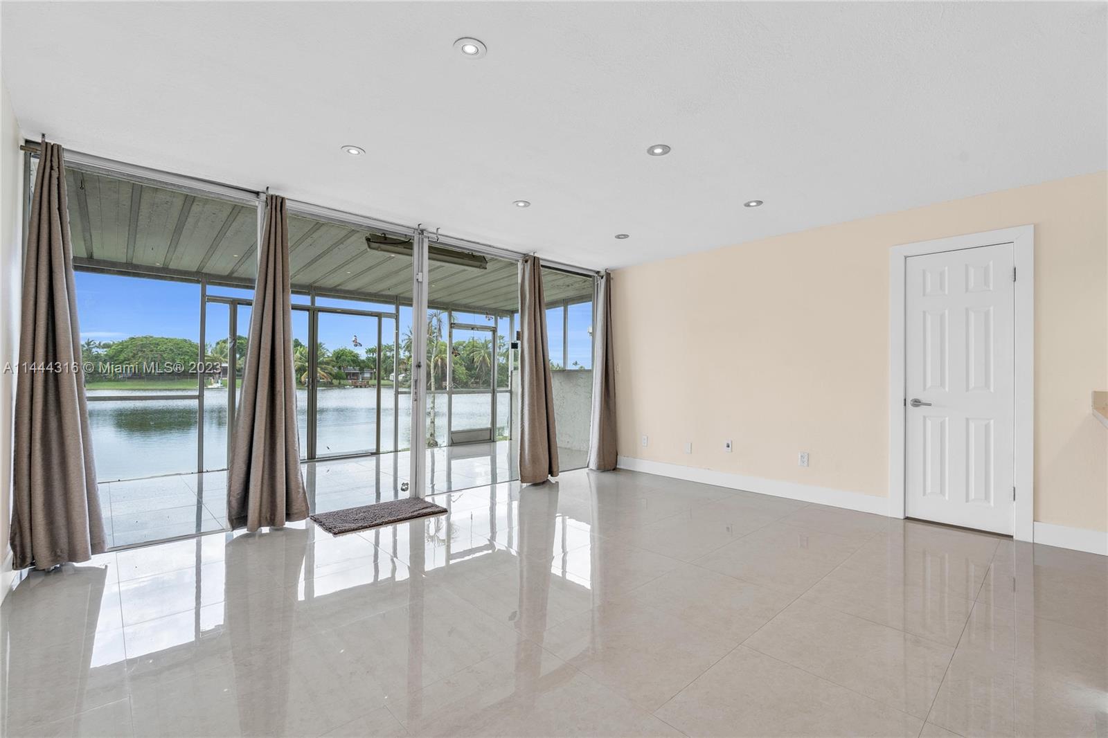 14001 Southwest 84th Street, Unit 1308 Miami, FL 33183 - Photo 3 of 47 a view of an empty room with glass door