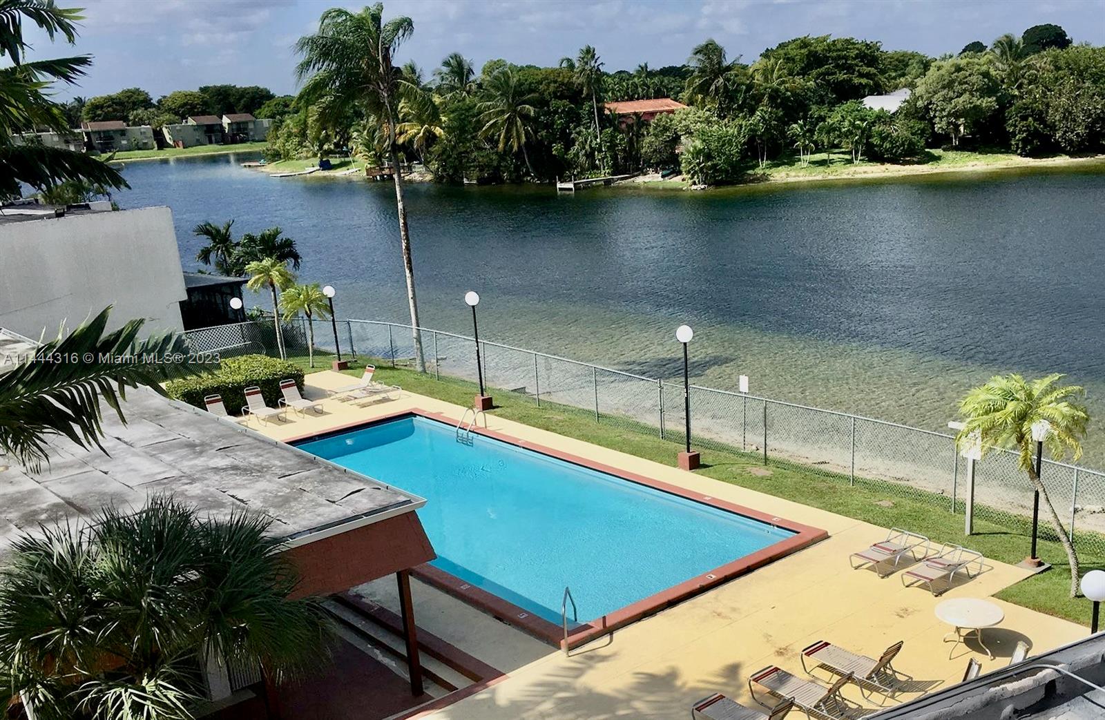 14001 Southwest 84th Street, Unit 1308 Miami, FL 33183 - Photo 34 of 47 a view of a swimming pool with a patio