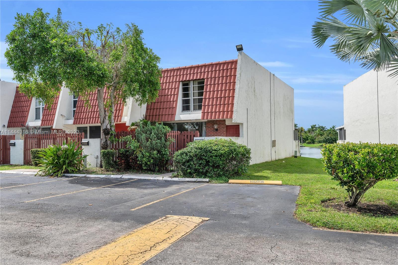 14001 Southwest 84th Street, Unit 1308 Miami, FL 33183 - Photo 4 of 47 a front view of a house with a yard and a garage
