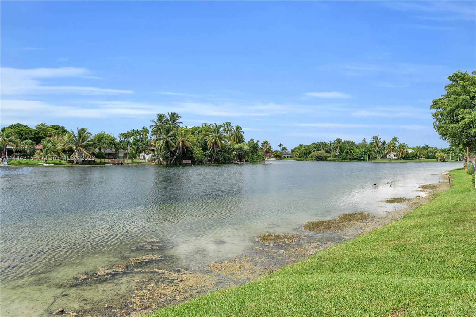 14001 Southwest 84th Street, Unit 1308 Miami, FL 33183 - Photo 41 of 47 a view of a lake with houses in the background